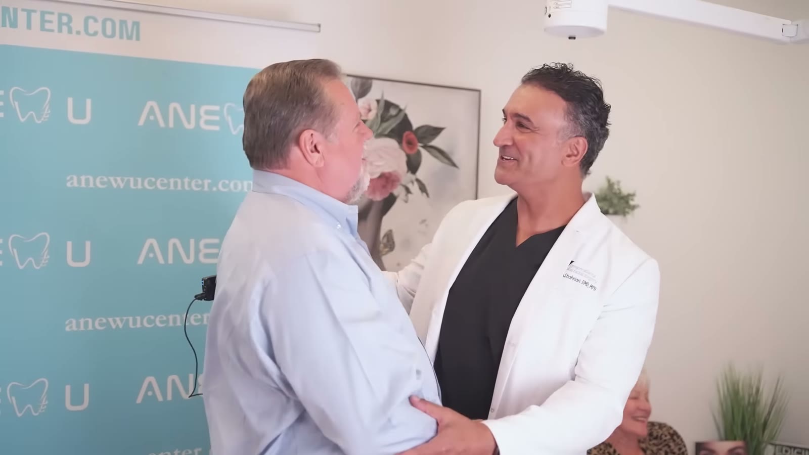 Dr. Abtin Shahriari greeting a patient at ANEWU